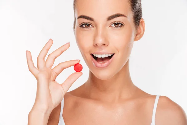 Beauty portrait of a beautiful young woman taking pill — Stock Photo, Image