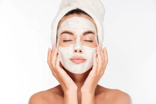Woman with eyes closed and white facial mask on face — Stock Photo, Image