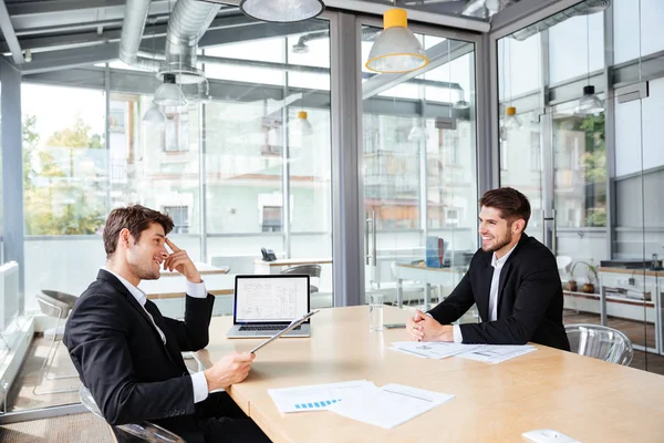 Two happy young businessmen working together on business meeting — Stock Photo, Image