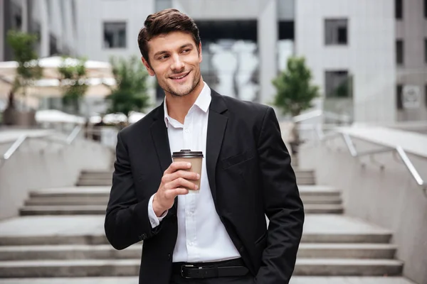 Glücklich attraktiver junger Geschäftsmann, der Kaffee in der Stadt trinkt — Stockfoto