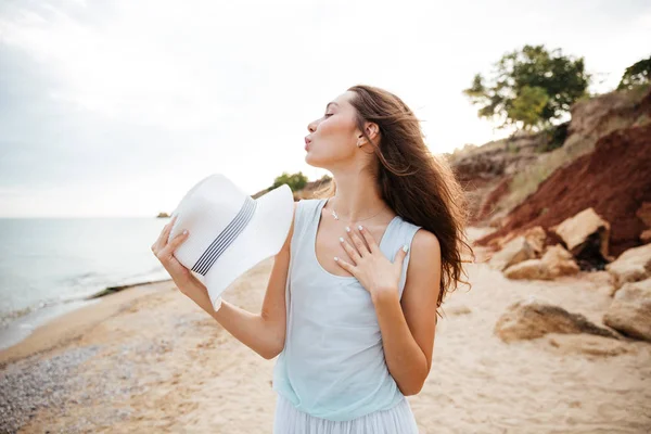 Cute playful young woman standing on the beach — Stock Photo, Image