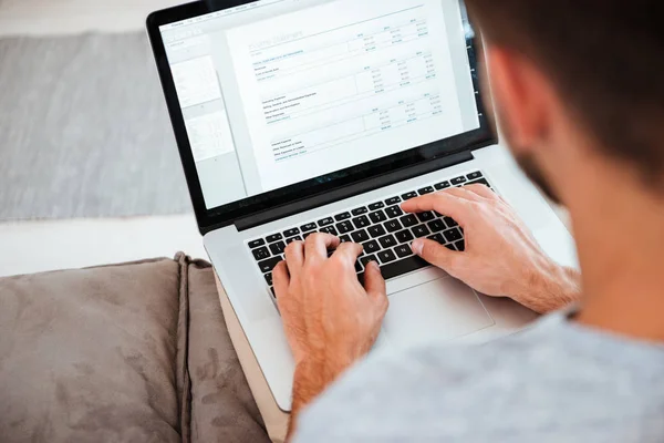 Cropped image of man typing by laptop. Focus on hands — Stock Photo, Image