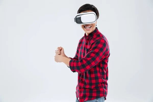 Man wearing virtual reality device and holding imagine tennis racket — Stock Photo, Image