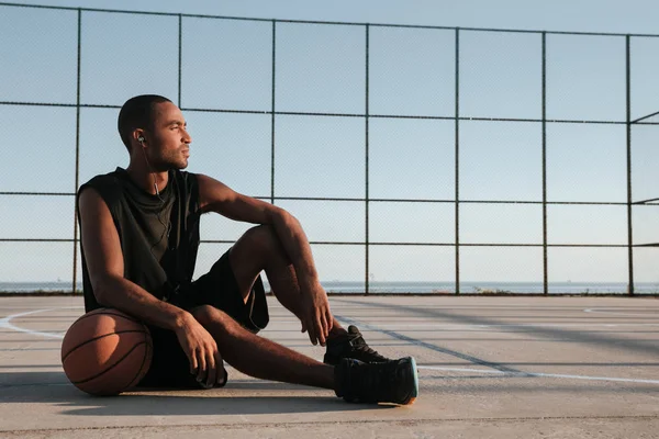 Portrait of a tired african basketball player resting after game — Stock Photo, Image