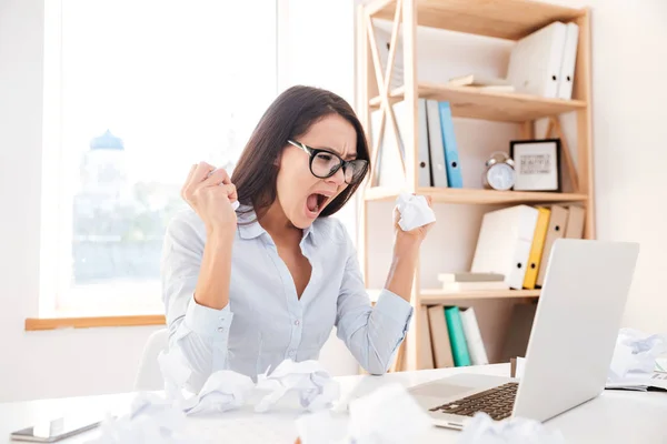 Angry businesswoman screaming while tear paper — Stock Photo, Image