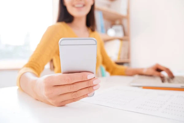 Cropped image of a woman using smartphone — Stock Photo, Image
