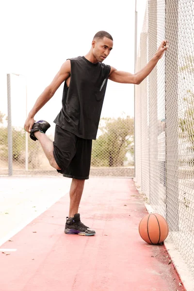 Young african basketball player making sport exercises — Stock Photo, Image