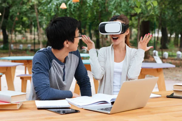 Couple using virtual reality glasses and having fun at table — Stock Photo, Image