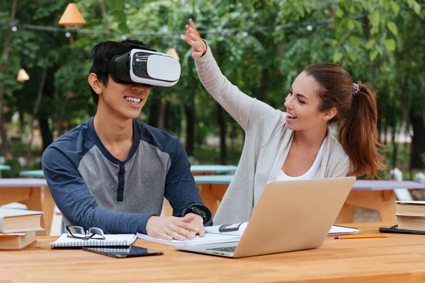 Couple with virtual reality glasses using laptop and having fun — Stock Photo, Image