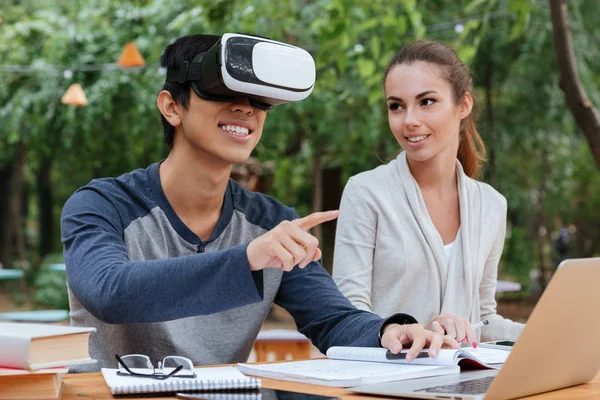 Happy young couple using virtual reality glasses outdoors — Stock Photo, Image