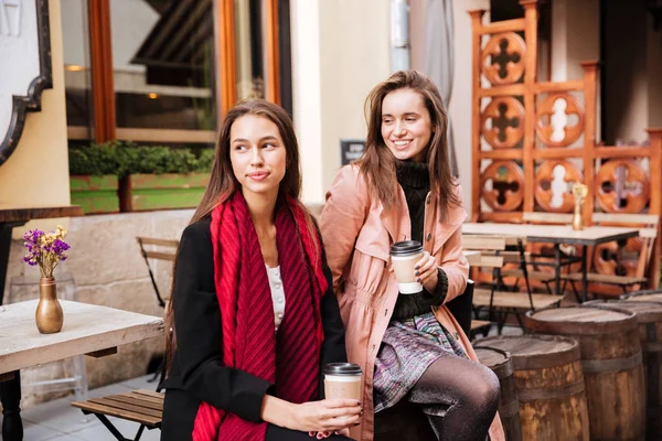 Two models in coats are sitting — Stock Photo, Image
