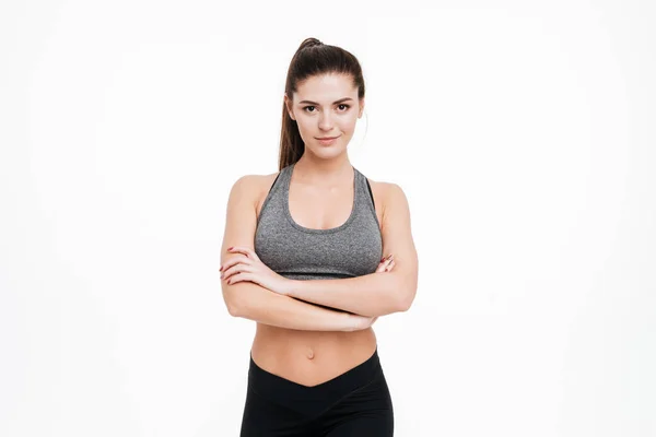 Sports woman standing with arms folded and looking at camera — Stock Photo, Image