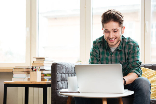 Man looking at laptop in office