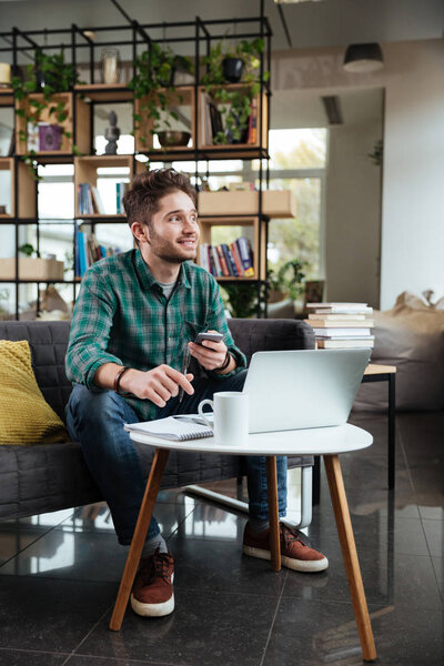 Vertical image of handsome man writing something