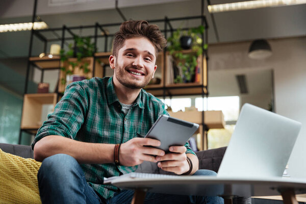 Man with tablet on sofa