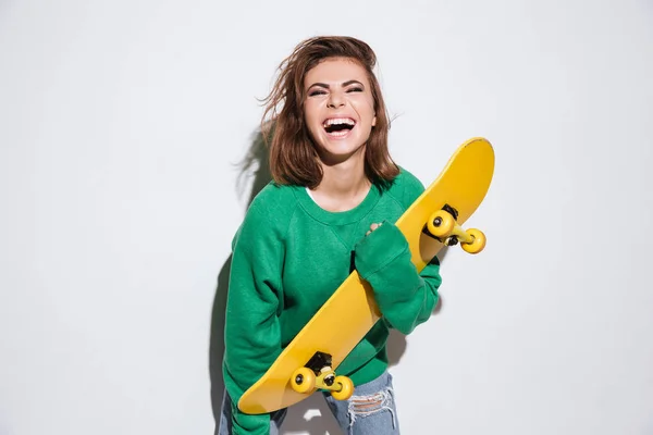 Pretty skater lady holding skateboard. — Stock Photo, Image