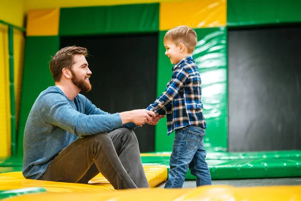 Otec hrál s jeho malým synem na krytý zábavní park — Stock fotografie