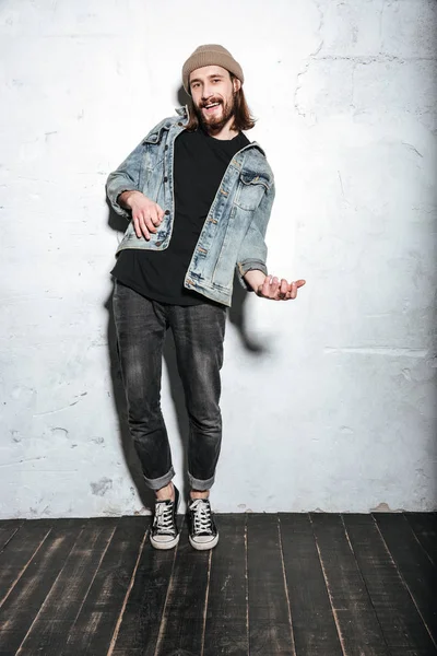 Attractive happy bearded hipster man play on imagined guitar — Stock Photo, Image