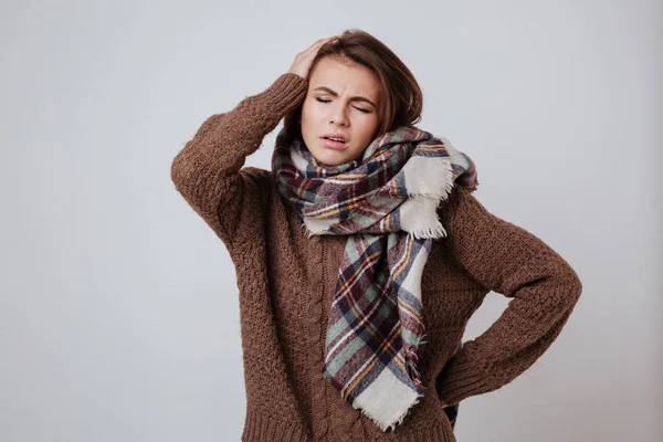 Pensive woman in sweater and scarf — Stock Photo, Image