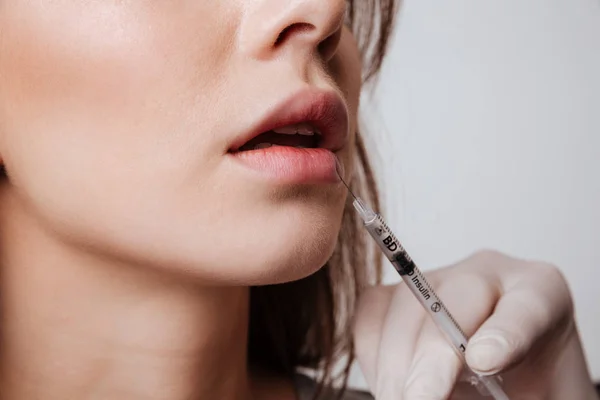 Cropped image of young woman make lip injections. — Stock Photo, Image