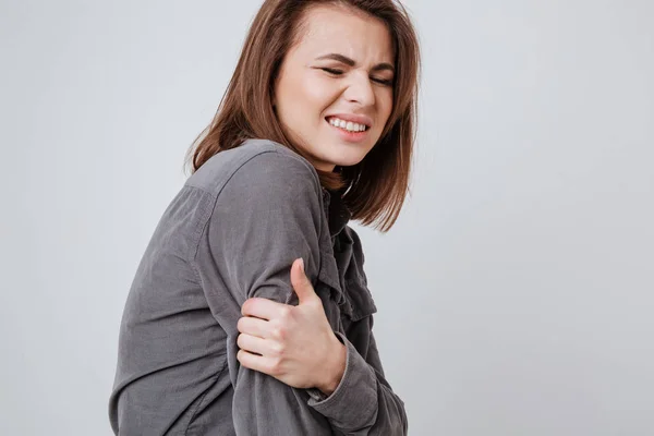 Sick young lady touching her hand. — Stock Photo, Image