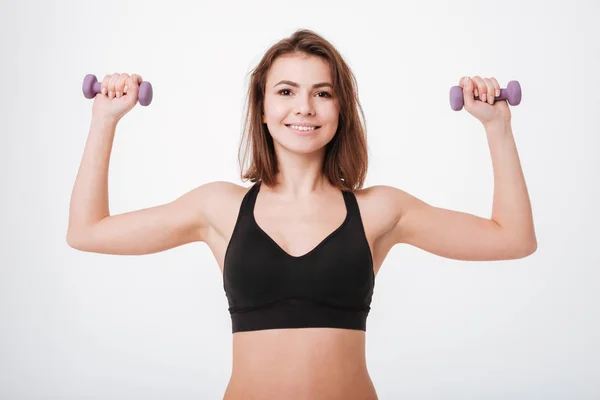Glada unga fitness lady gör övningar med hantlar — Stockfoto