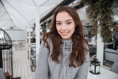 Kafede oturan Kazak giymiş inanılmaz genç bayan