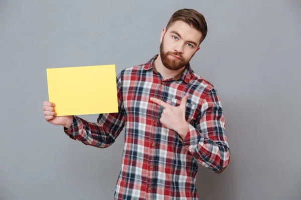 Handsome bearded man holding copyspace blank — Stock Photo, Image