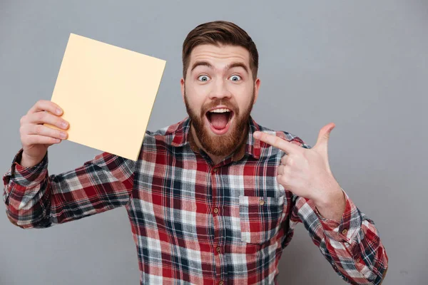 Handsome bearded man holding copyspace blank — Stock Photo, Image