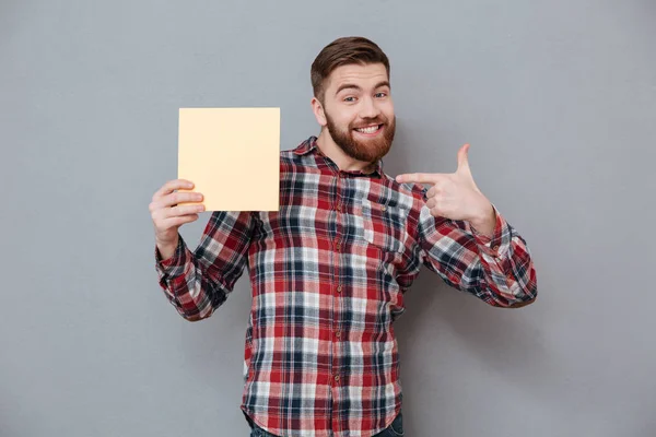 Man in shirt holding blank board — Stock Photo, Image