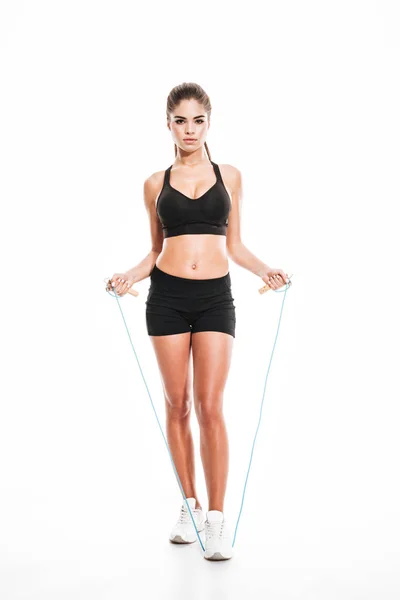 Fitness muscular woman with jumping rope standing — Stock Photo, Image