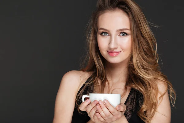 Amazing woman holding cup of coffee