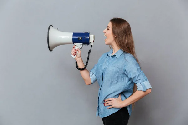 Side view of Woman screaming in megaphone — Stock Photo, Image