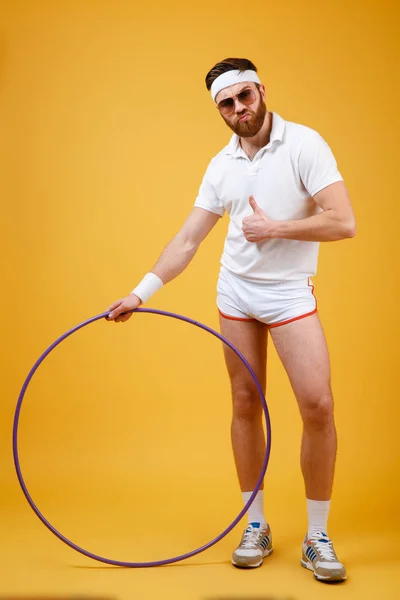 Handsome sportsman standing with gymnastic hoop make thumbs up gesture — Stock Photo, Image