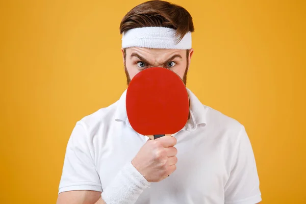 Emocional joven deportista sosteniendo raqueta para tenis cubriendo la boca . — Foto de Stock