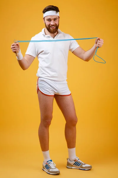 Cheerful young sportsman holding skipping rope — Stock Photo, Image