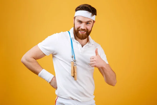 Happy young sportsman holding skipping rope make thumbs up gesture — Stock Photo, Image