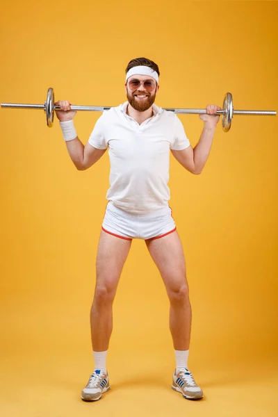 Full length portrait of a man athlete exercising with barbell — Stock Photo, Image