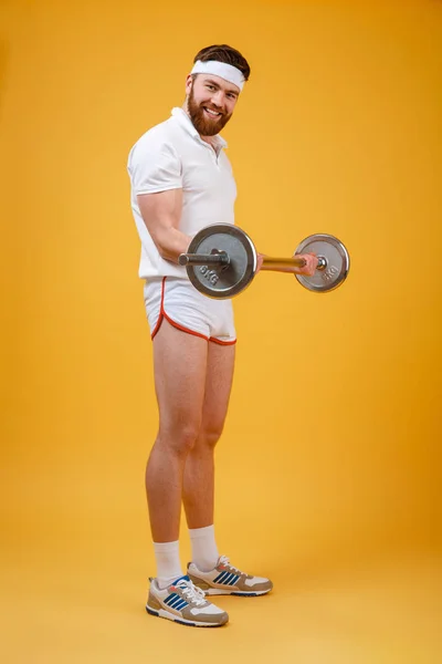 Smiling bearded fitnes man doing workout with barbell — Stock Photo, Image