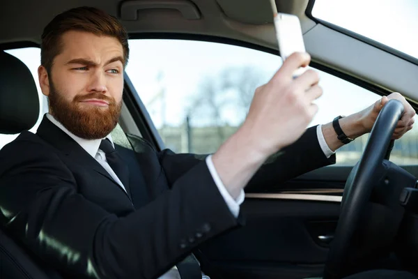 Side view of bearded business man making selfie — Stock Photo, Image