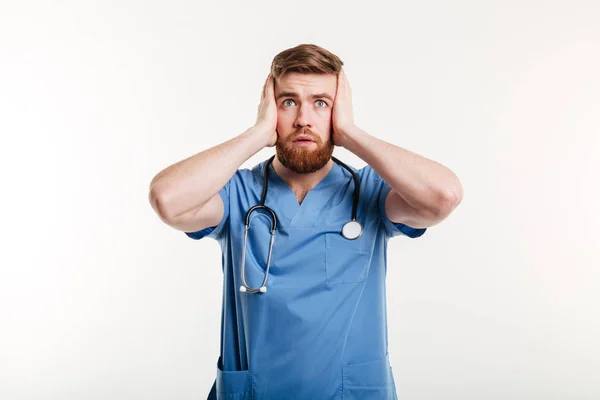 Portrait of male doctor making deaf gesture by covering ears — Stock Photo, Image
