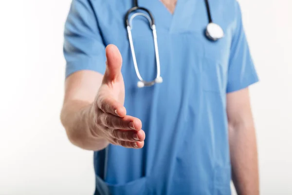 Close up of doctor giving hand for handshake — Stock Photo, Image