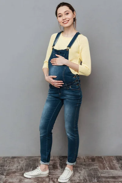 Довольно счастливая беременная женщина позирует — стоковое фото