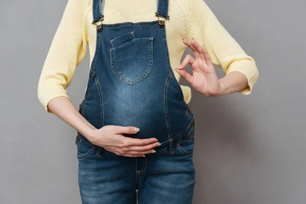 Cropped image of pregnant lady make okay gesture. — Stock Photo, Image