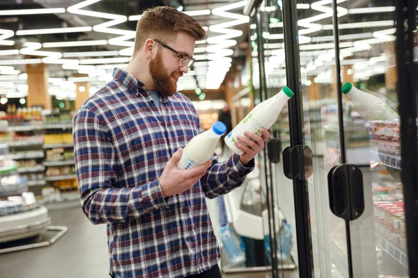 Seitenansicht eines bärtigen Mannes, der sich für Milch entscheidet — Stockfoto