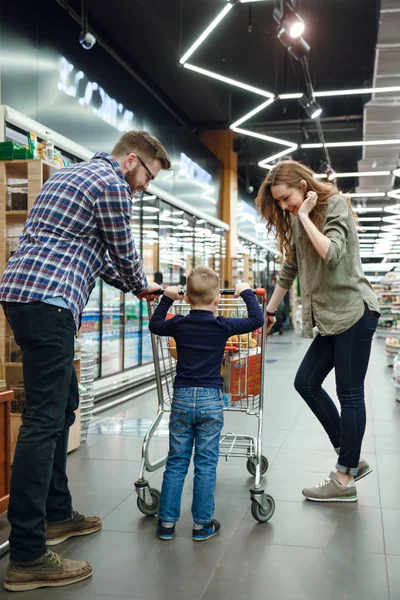 Vista trasera de la familia en el supermercado —  Fotos de Stock