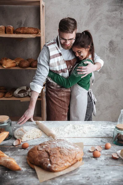 Younh couple hugging in kitchen — Stock Photo, Image