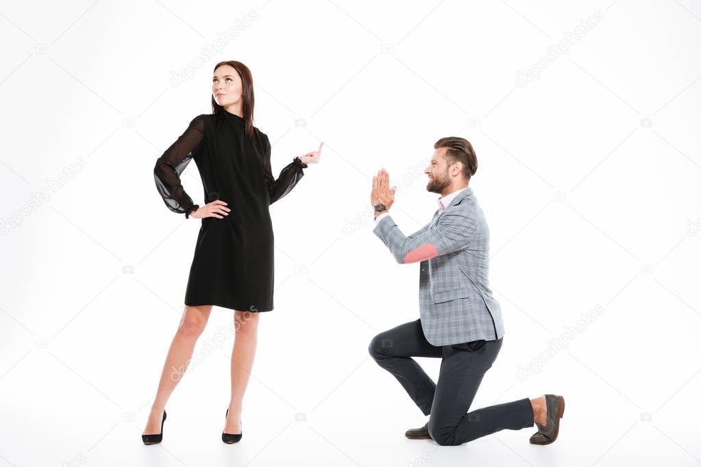 Offended young loving couple standing isolated