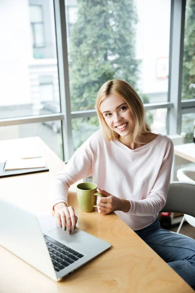 Happy lady sitting in office coworking while using laptop — Stock Photo, Image