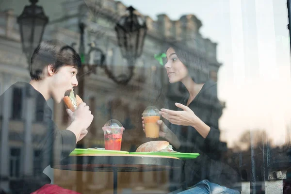 Joyeux jeune homme assis au café avec sa sœur — Photo